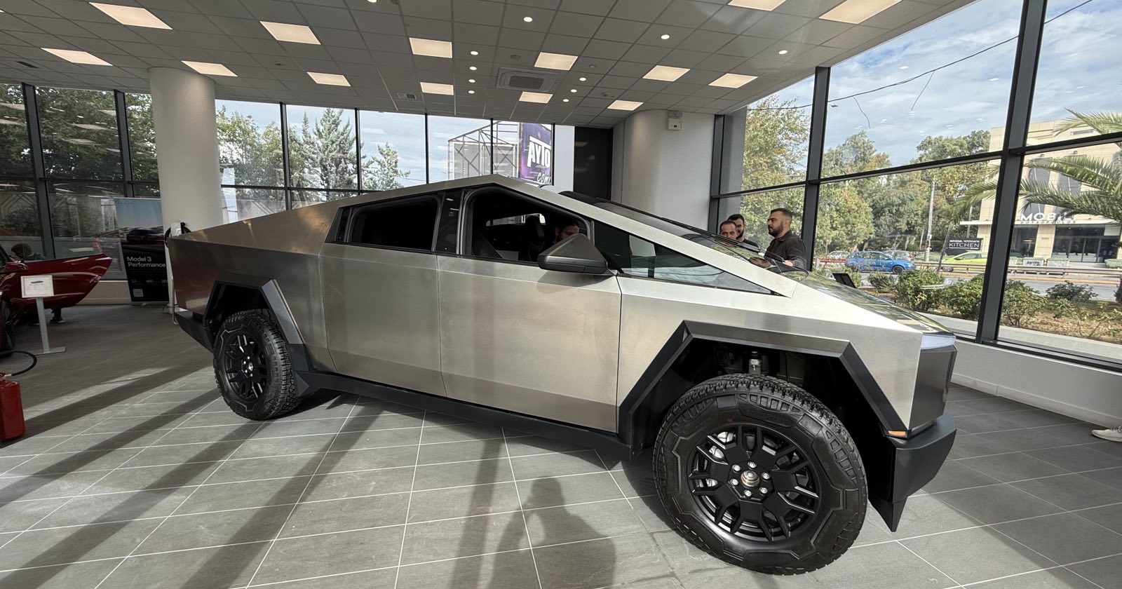Side view of a Tesla Cybertruck on display inside a Tesla showroom in Athens